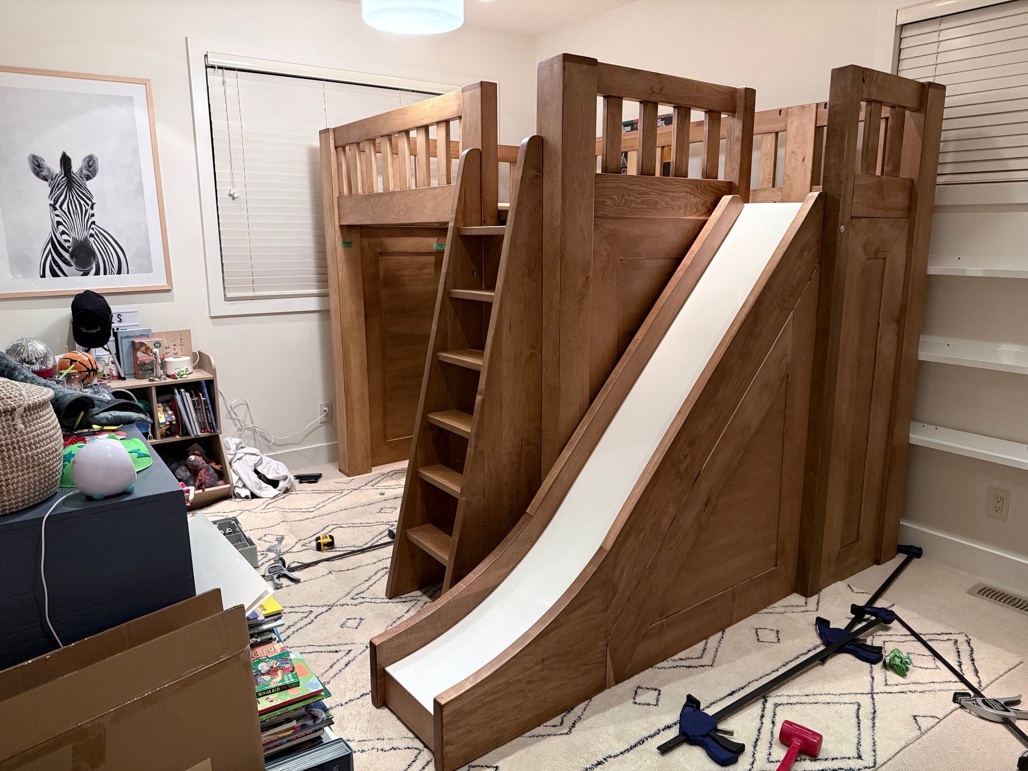 Custom wooden loft bed with integrated slide for boys' bedroom